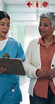 Clipboard, nurse and senior patient in hospital lobby together with application form, results and plan. Healthcare, checklist and happy women walking for discussion, discharge and medical stay survey
