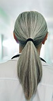 Back, woman and doctor walking at hospital, shift arrival and ward rounds for patient care in lobby. Female person, punctual and medical routine in hallway, emergency response and healthcare service