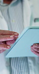 Tablet, man and hands of doctor in hospital for research on medical diagnosis or treatment planning. Digital technology, scrolling and mature healthcare worker with telehealth on app in clinic.