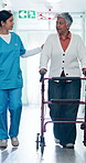 Walker, patient and nurse in hallway for mobility, support and rehabilitation for injury healing. Talk, aid and help with woman  and caregiver in hospital for hip replacement, senior care or recovery
