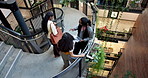 Talking, stairs and business people in office with tablet for meeting, conversation and walking with team. Above, workplace and women on tech for discussion, chat and greeting at company in lobby