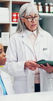 Pharmacist, tablet and women for discussion, inventory or online medication order in pharmacy. Medical, people and digital tech for healthcare stock, pills or prescription for telehealth at drugstore
