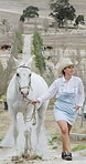 Outdoor, cowgirl and woman with horse, walk and travel on peaceful adventure in countryside or farm. Happy person, journey and bonding with animal in nature, trip together and training stallion