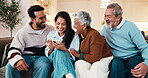 Family, scroll and laugh with phone in lounge, happy couple and watching video with senior parents. Generations, smile and funny series on mobile app, point and conversation with old people in house