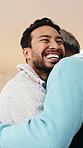 Love, man and hug with senior father for reunion, conversation and relax together on couch. Embrace, elderly parent and adult son talking for care, support and bonding with happiness at home lounge