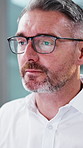 Reading, glasses and business man in office for thinking, reflection or planning at finance agency. Corporate, mature and person with frames for eye strain with idea, thoughtful and investment choice