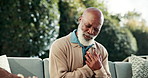Senior, outdoor or black man with chest pain for cardiac arrest, heart attack or hypertension. Elderly, male person or ache with cramp on sofa in backyard for health risk, medical emergency or asthma