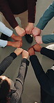 Above, circle and business people with fist bump for team, support and motivation for goals. Huddle, coworking and men with women in meeting for collaboration, agreement and hands together in office