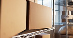 Shelf, boxes and logistics in empty warehouse for shipping, supply chain and ecommerce inventory. Cardboard, package and storage unit in stock room, distribution and small business merchandise