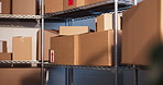 Shelf, boxes and shipping in empty warehouse with safety label, supply chain or ecommerce logistics. Cardboard, package sticker and storage room with stock, small business or fragile goods protection