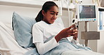 Typing, phone and child in hospital bed with internet, online chat and connection in clinic. Happy, healthcare and girl on cellphone for social media, website and distraction for surgery recovery