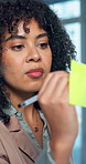 Sticky note, strategy and woman writing in office for financial planning, reminder or schedule. Glass wall, person and brainstorming business idea for investment objectives, agenda or problem solving