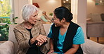 Nurse, laughing and cane with old woman on sofa in house for empathy, elderly care and connection. Support, retirement home and volunteer with senior person with a disability and caregiver for hug