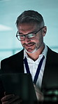 Reading, research and businessman with tablet at night, happy and financial review on web in office. Wealth manager, smile and mature person with tech, typing or working late with project in business