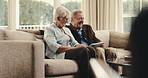 Senior, couple and laughing with tablet on sofa for funny joke, movie or online streaming in home. Elderly, man and woman with smile or technology for comedy show, entertainment or humor in house