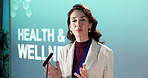 Woman, seminar or podium with speech for healthcare, medical awareness campaign or event. Female person, speaker or presentation with microphone or company pitch for innovation, health and wellness