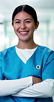 Face, woman and nurse with confidence, medical service and arms crossed with smile in hospital. Happy, healthcare professional and female person in clinic, about us or portrait of medicine expert