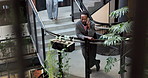 Stairs, man and phone call in office, talking or update for sustainability report at ESG startup. African person, mobile or conversation at steps in business, eco friendly chat or communication above