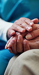 Empathy, nurse or old person in home with holding hands, comfort or consoling for medical diagnosis. Health, senior patient or caregiver with support, understanding or sympathy for evaluation results