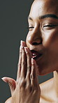 Smile, beauty and woman blow kiss in studio for self care, skin glow and skincare cosmetics. African person, gray background and touch for natural dermatology, wellness and flawless shine results