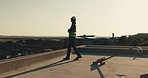 Walking, construction and man on rooftop for planning, property development and project. Architecture, civil engineering and person with helmet, thinking and outdoor for infrastructure expansion