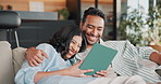Relax, laugh and couple on sofa with tablet, online joke and website with funny meme on weekend. Happy, home and man with woman on tech for connection, bonding and conversation with internet humor