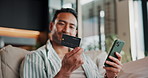 Credit card, phone and man in home for online shopping, ecommerce purchase and digital banking. Happy, sofa and person on mobile app with debit info for subscription, payment and website store sale