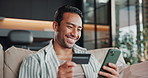 Credit card, phone and man on sofa for online shopping, ecommerce purchase and digital banking. Happy, home and person on mobile app with debit info for subscription, payment and website store sale