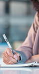 Woman, hands or writing with notebook in office for reminder, schedule planning or daily agenda. Female person, employee or event planner taking notes with diary for project ideas, tasks or checklist