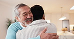 Hug, smile and man with senior father in home with bonding, connection or good news together. Happy, love and adult son embracing elderly dad in living room for support, trust or family in house.