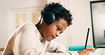 Child, headphones and writing in home with homework, learning critical thinking and listen to music. Boy, study and taking notes in house with school assignment, education and audio tech for song.