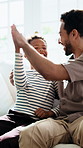 High five, watching tv and father with son on sofa in home for sports goal, streaming service and support. Game achievement, celebration and relax with man and child in living room in family house