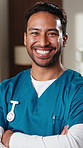 Face, surgeon and healthcare with man at hospital, medical professional and integrity as nurse. Doctor, physician or surgical specialist with ambition, pride and happy in medicine with arms crossed