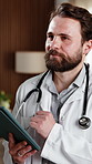 Doctor, thinking and man with tablet in hospital, smile and review test results on app or healthcare. Clinic, medical professional and happy person with tech, reflection and reading health report