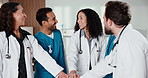 Happy, people and doctor with hands together in hospital for teamwork, mission or success. Excited, group or medical employees piling with smile, stack or high five for winning or clinic achievement
