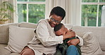 Mom, child and black family with hug on sofa for love, care or bonding together in home. Happy, mother and smile with kid, son or embrace on couch for comfort, weekend break or holiday in house