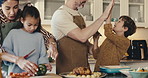 Cooking, high five and family in kitchen at house for bonding, care and learning to cut vegetables. Happy, celebration and children with parents for preparing dinner, meal or supper for development.
