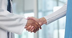 Meeting, handshake and doctor with nurse in hospital for greeting, welcome and discussion in lobby. Healthcare, clinic and people shaking hands for talking, agreement and teamwork for medical service