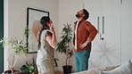 Argument, angry and couple in house with fight, disagreement and conflict in toxic relationship. Upset, partner and people in lounge with issue, tension and emotional confrontation in marriage.