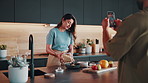 Recording, cooking and people in kitchen for breakfast tutorial on health, wellness or diet blog. Couple, live streaming and man with woman for preparing cereal together for vlog in apartment.