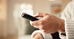 TV remote, choice and hand of person in living room for volume, media selection or change channel. Man, tech and control with bokeh for entertainment, browsing subscription service and movie in home