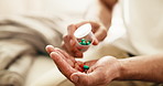 Pills, health and hands of person on sofa for medical prescription, supplements and drugs. Medicine, wellness and antibiotics with man in living room of home for medication, recovery and vitamins