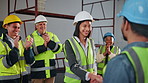 Architect, builder and handshake on site with applause, well done or approval of property renovation. Happy, people clap and shaking hands in building with construction worker, deal and partnership.