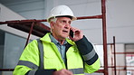 Phone call, man and construction worker on site with planning for renovation, repairs or maintenance. Scaffolding, cellphone and mature civil engineer on mobile discussion for property development.