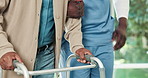Physio, hands and support man with walker for exercise, movement and injury rehabilitation in clinic. Healthcare worker, help and person with mobility aid, physical therapy and healing from stroke.