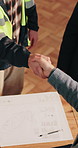 Blueprint, meeting and construction team with handshake in office for building agreement or approval. Floor plan, welcome and civil engineer shaking hands with foreman for renovation contract on site