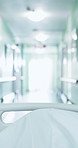 Sick, person and bed at hospital with gurney, admission and emergency for urgent surgery. Pov, moving and transfer patient in hallway with stretcher, critical care and operation room for healthcare