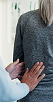 Physiotherapy, consulting and senior woman with back pain, osteoarthritis and recovery in clinic. Healthcare, support and elderly person at appointment for physical therapy, wellness and healing