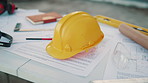 Hardhat, blueprint and strategy on construction site for civil engineering or infrastructure upgrade. Helmet urban planning and general work PPE for safety, architecture and outdoor workspace