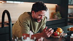 Smile, phone and tutorial with man in kitchen for diet video, ingredients or online instructions. Cooking, preparation and search with male person in apartment for recipe, health or nutrition in home